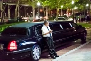 a chauffeur wait for the client who book a limo service